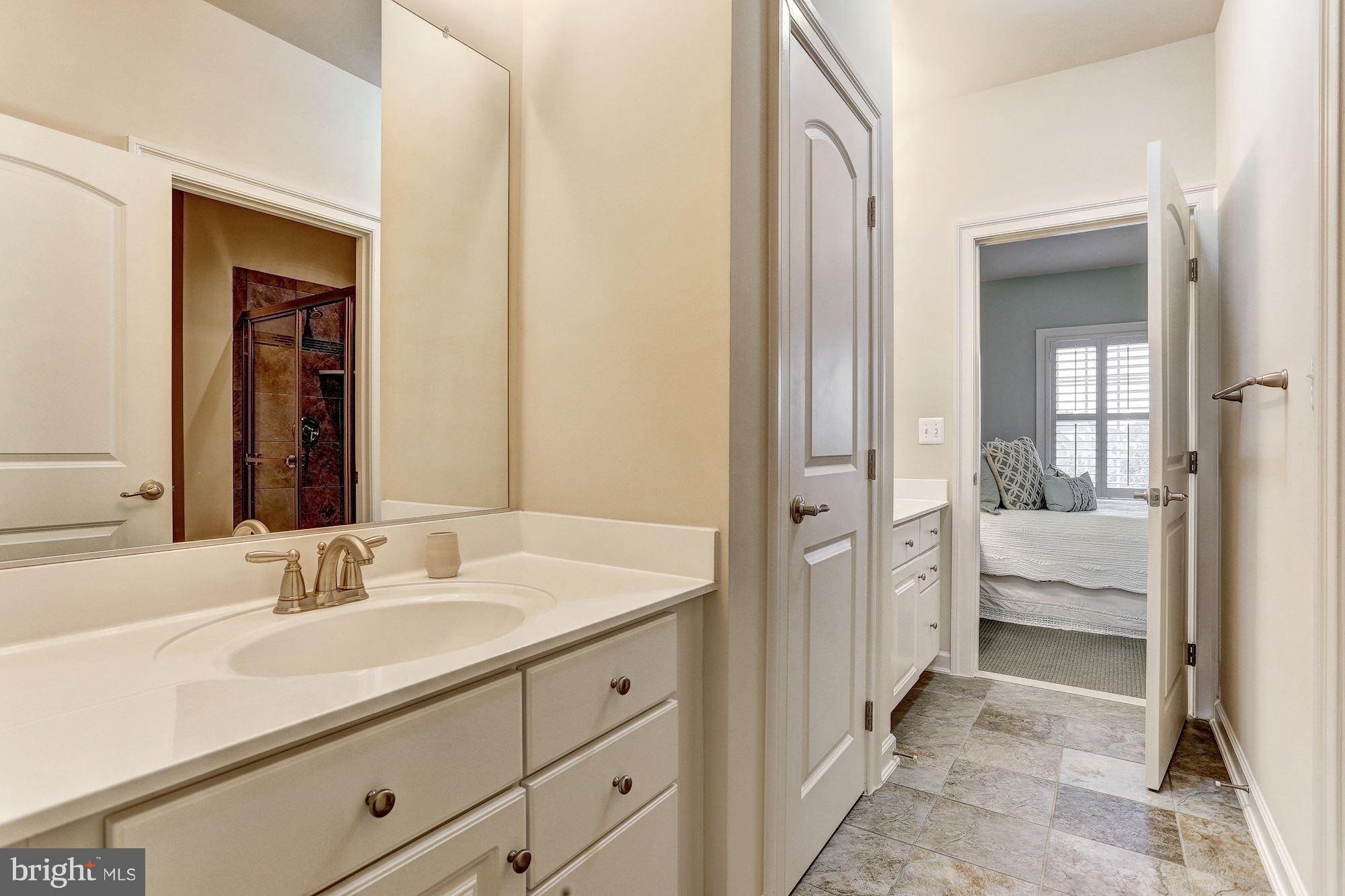 7806 Blue Ribbon Street Fulton, MD 20759 - Photo 18 of 30 a en suite bathroom with a double sink and mirror