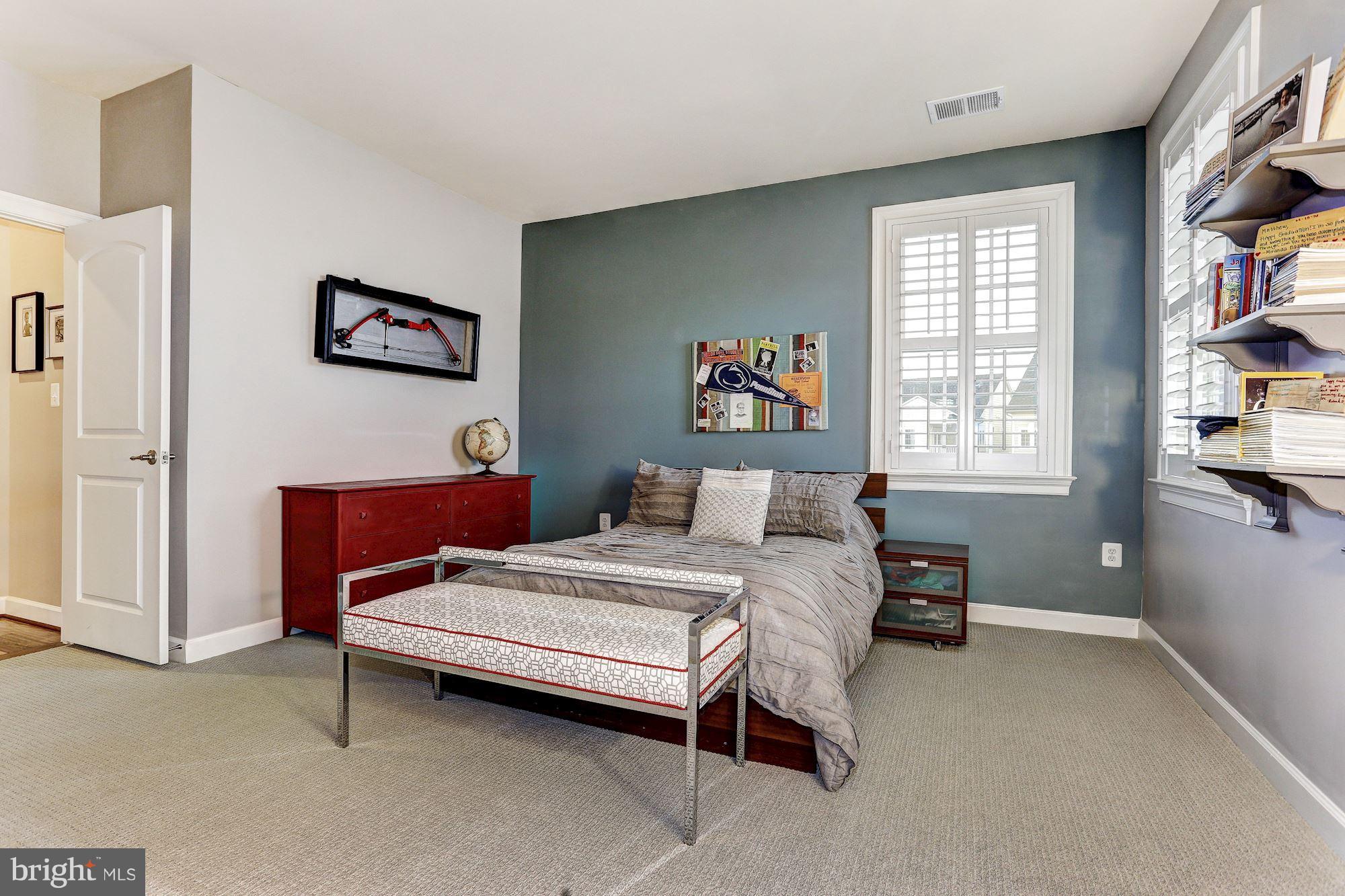 7806 Blue Ribbon Street Fulton, MD 20759 - Photo 19 of 30 a bedroom with a bed a dresser and a window