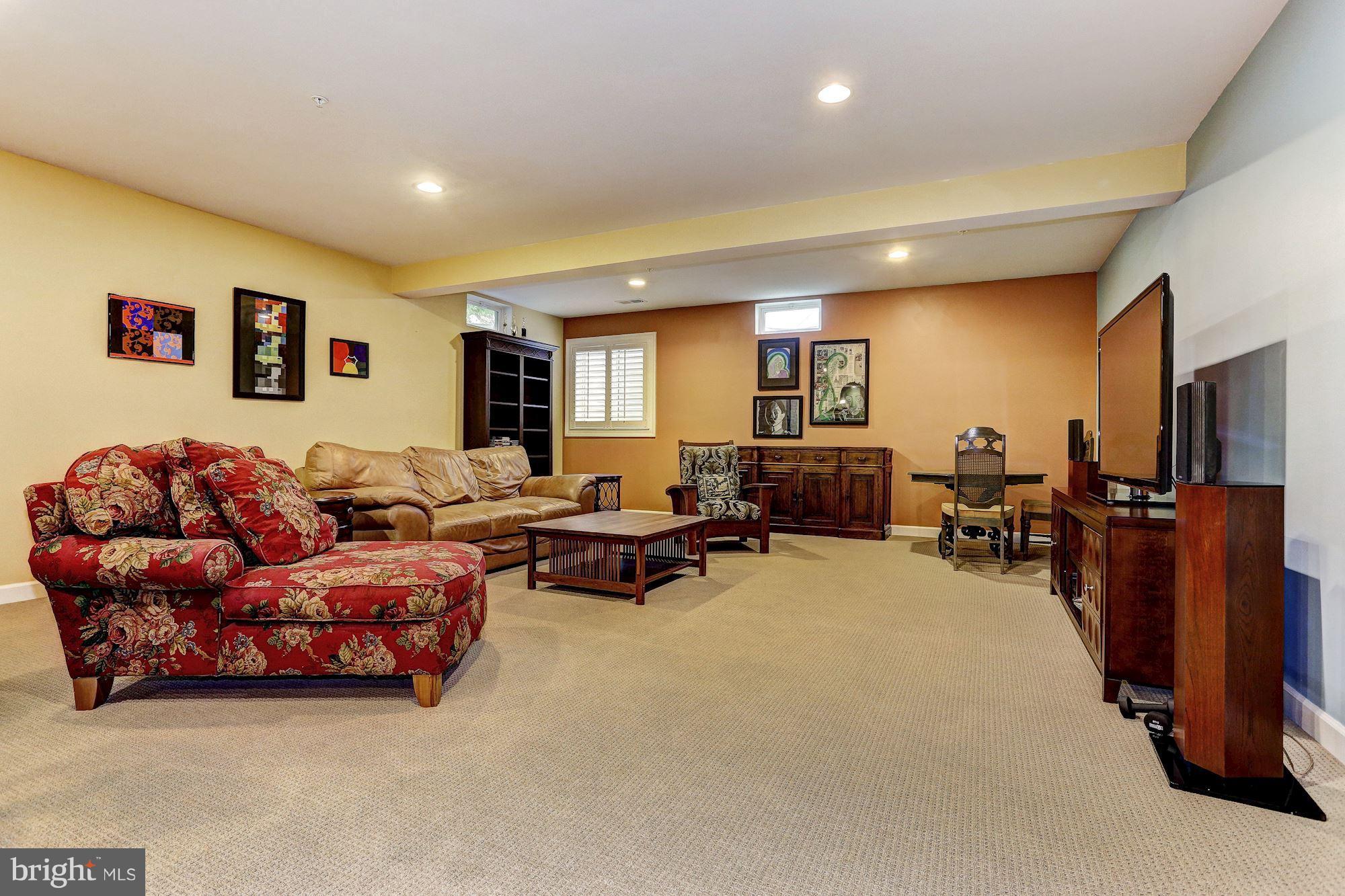 7806 Blue Ribbon Street Fulton, MD 20759 - Photo 21 of 30 a living room with furniture and a flat screen tv
