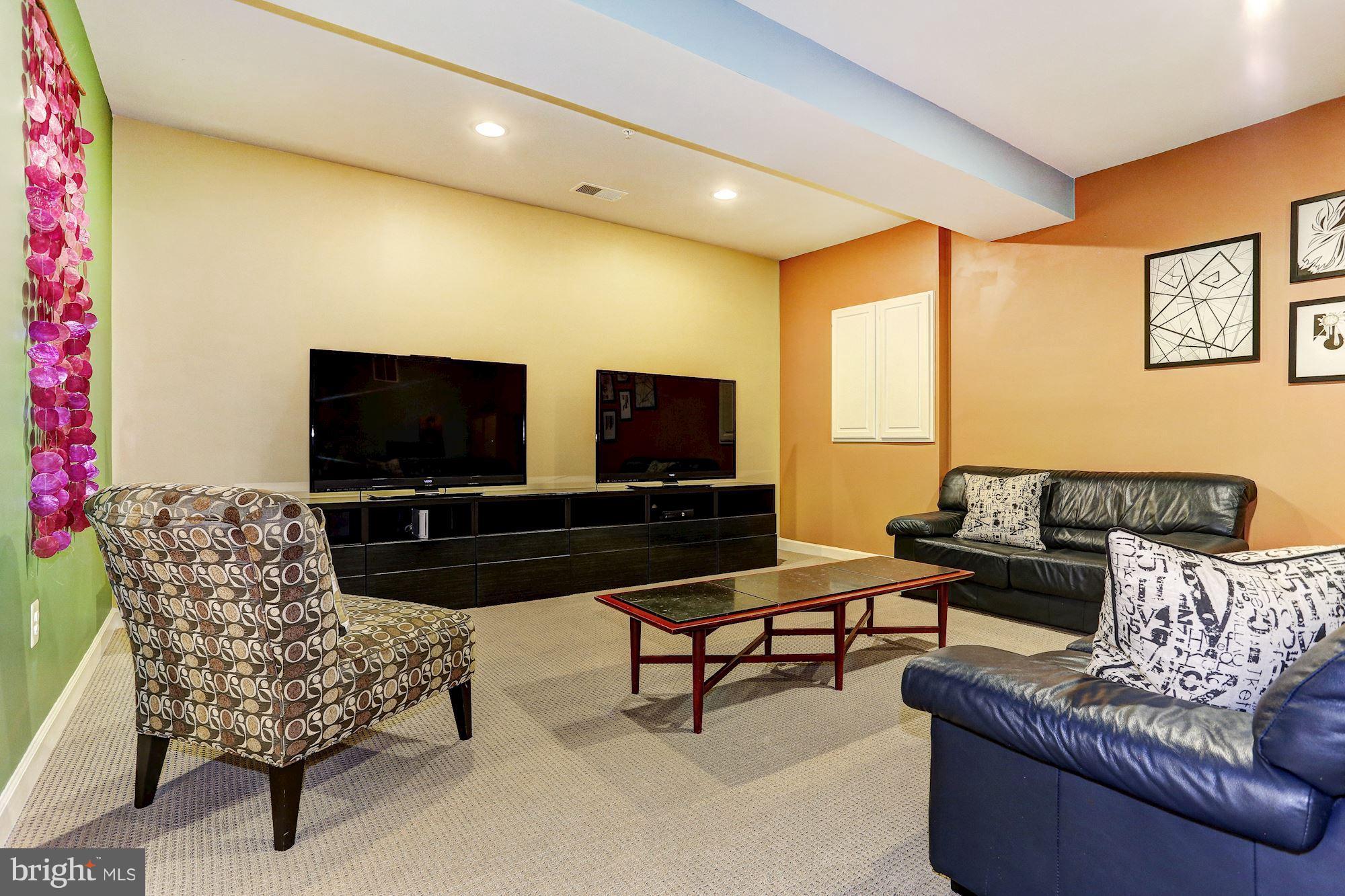 7806 Blue Ribbon Street Fulton, MD 20759 - Photo 22 of 30 a living room with furniture and a flat screen tv
