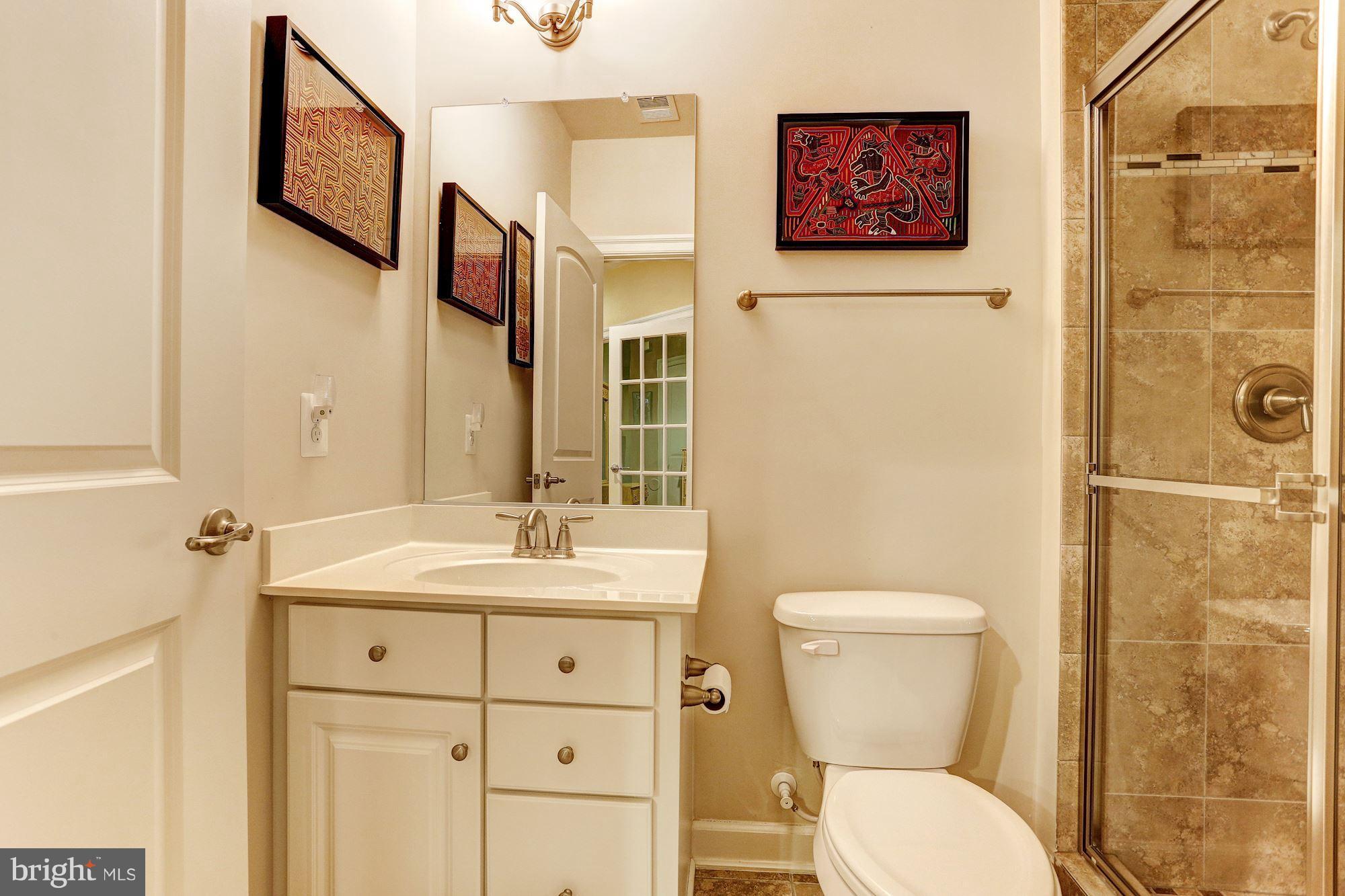 7806 Blue Ribbon Street Fulton, MD 20759 - Photo 24 of 30 a bathroom with a toilet sink and mirror