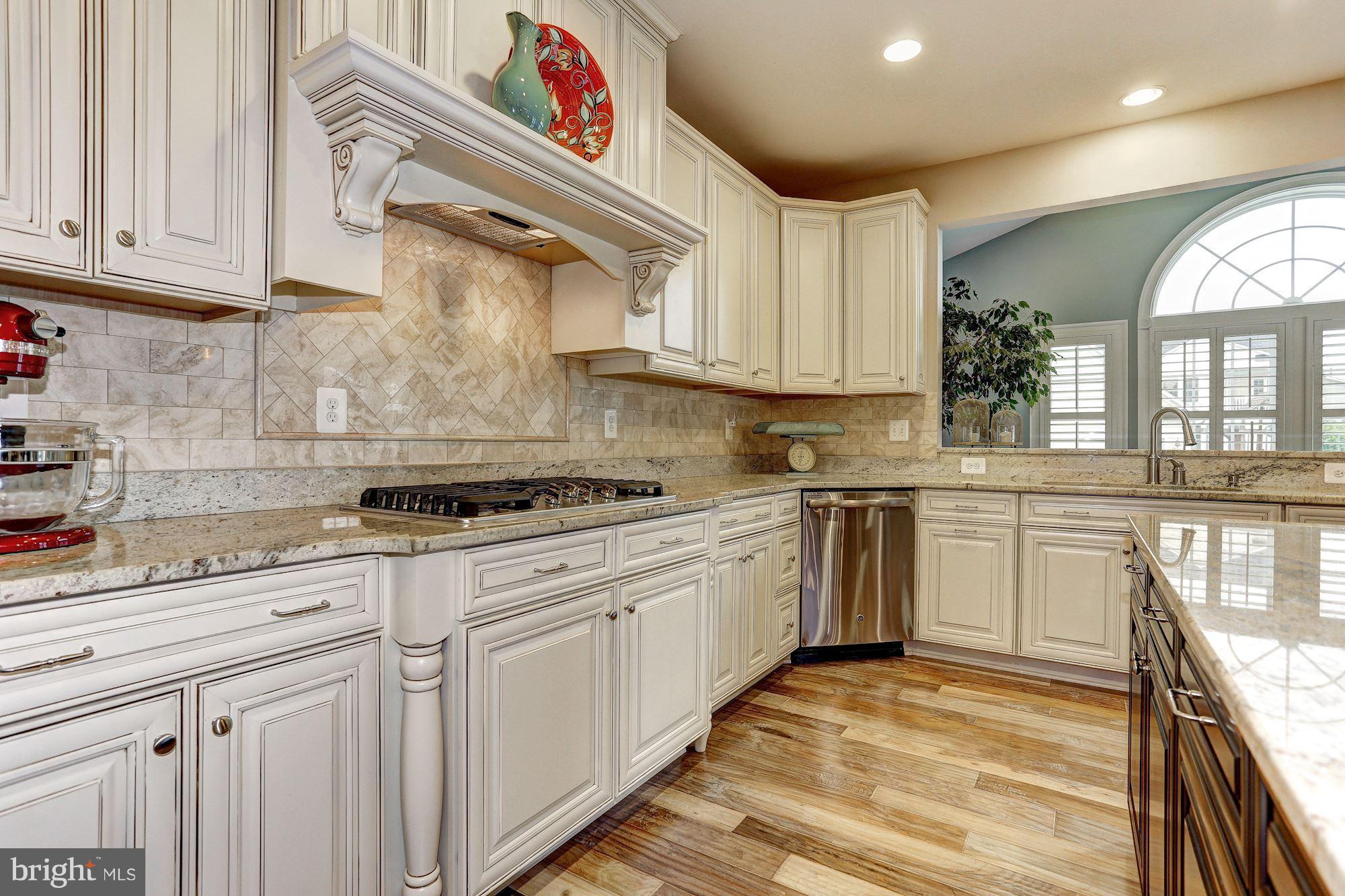 7806 Blue Ribbon Street Fulton, MD 20759 - Photo 8 of 30 a kitchen with granite countertop white cabinets and white appliances