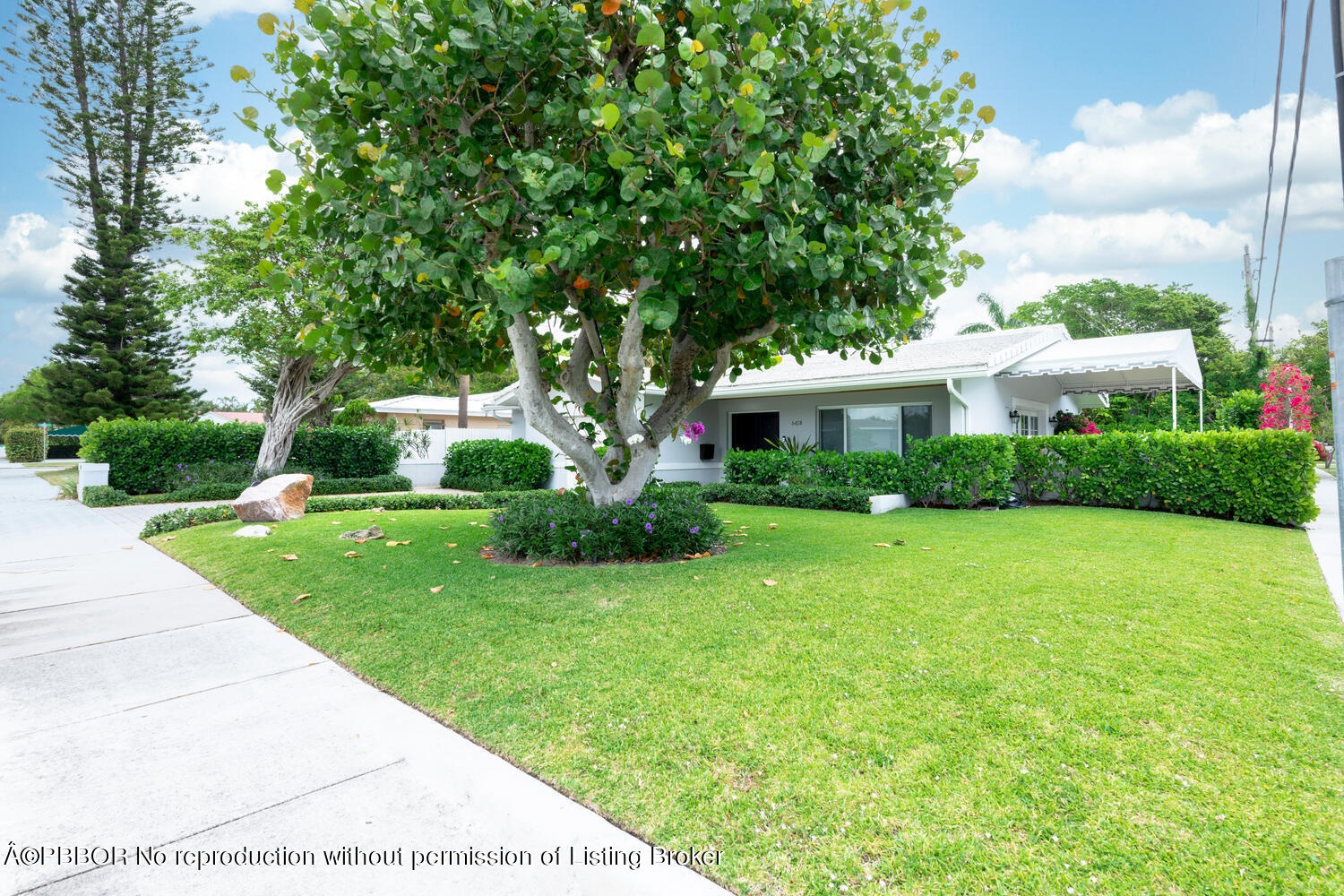 6408 Washington Road West Palm Beach, FL 33405 - Photo 1 of 19 a front view of a house with garden