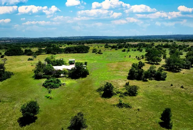 an aerial view of a house with yard