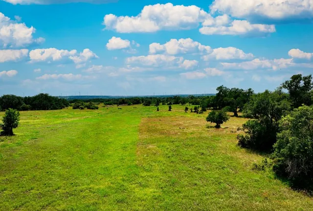 a view of a house with backyard porch and sitting area