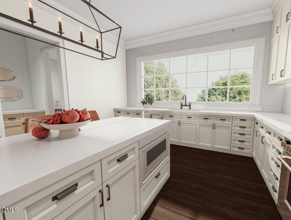 a kitchen with white cabinets and window