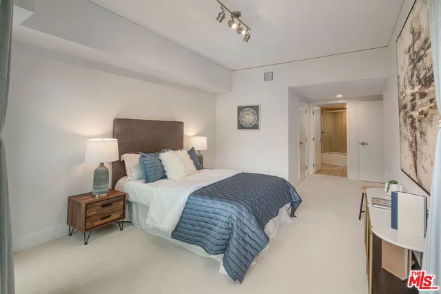 a bedroom with a bed and a mirror