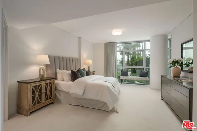 a spacious bedroom with a bed and a window