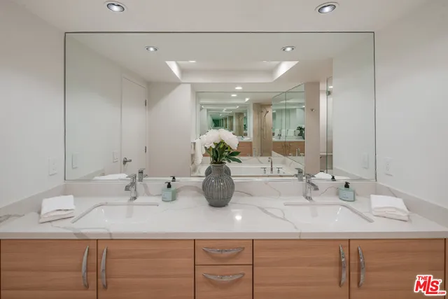 a bathroom with a double vanity sink and a mirror
