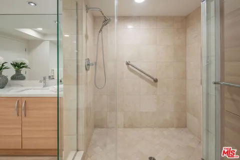 a bathroom with a shower and a sink