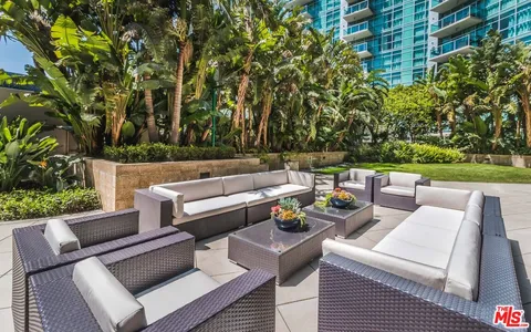 a view of a chairs and table in patio