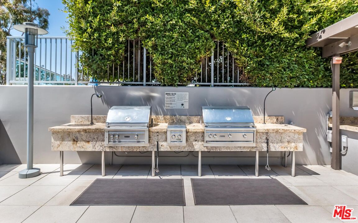 13650 Marina Pointe Drive, Unit 403 Marina del Rey, CA 90292 - Photo 37 of 47 a view of a patio with table and chairs with wooden floor and fence