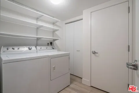 a utility room with cabinets washer and dryer