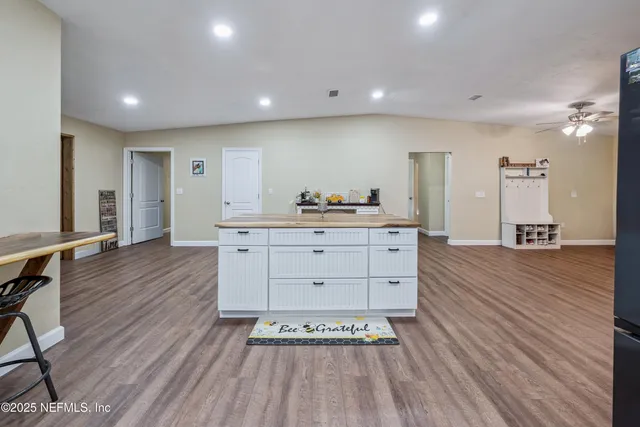 a kitchen with a sink cabinets and wooden floor