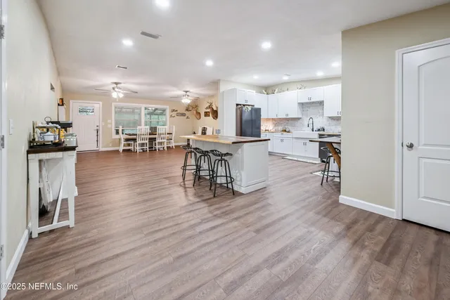 a view of a dining room with furniture wooden floor and chandelier