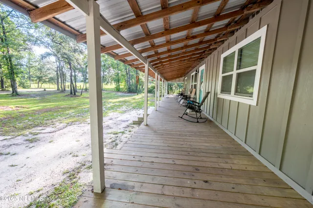 a swimming pool with outdoor seating and yard