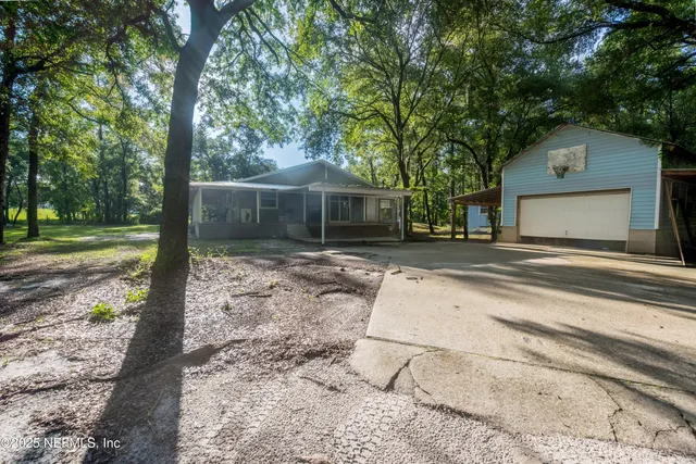 a backyard of a house with lots of green space and trees