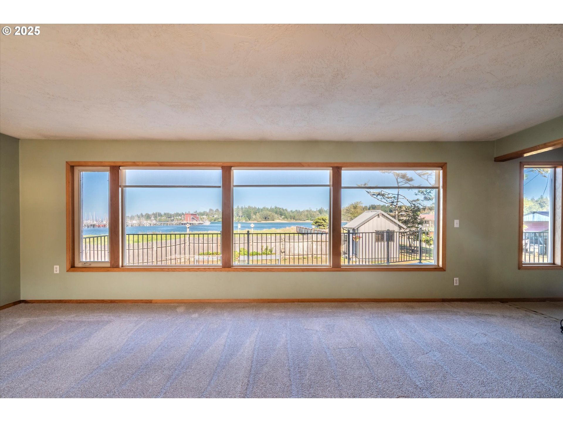 63347 Charleston Road Coos Bay, OR 97420 - Photo 16 of 48 an empty room with wooden floor and glass door