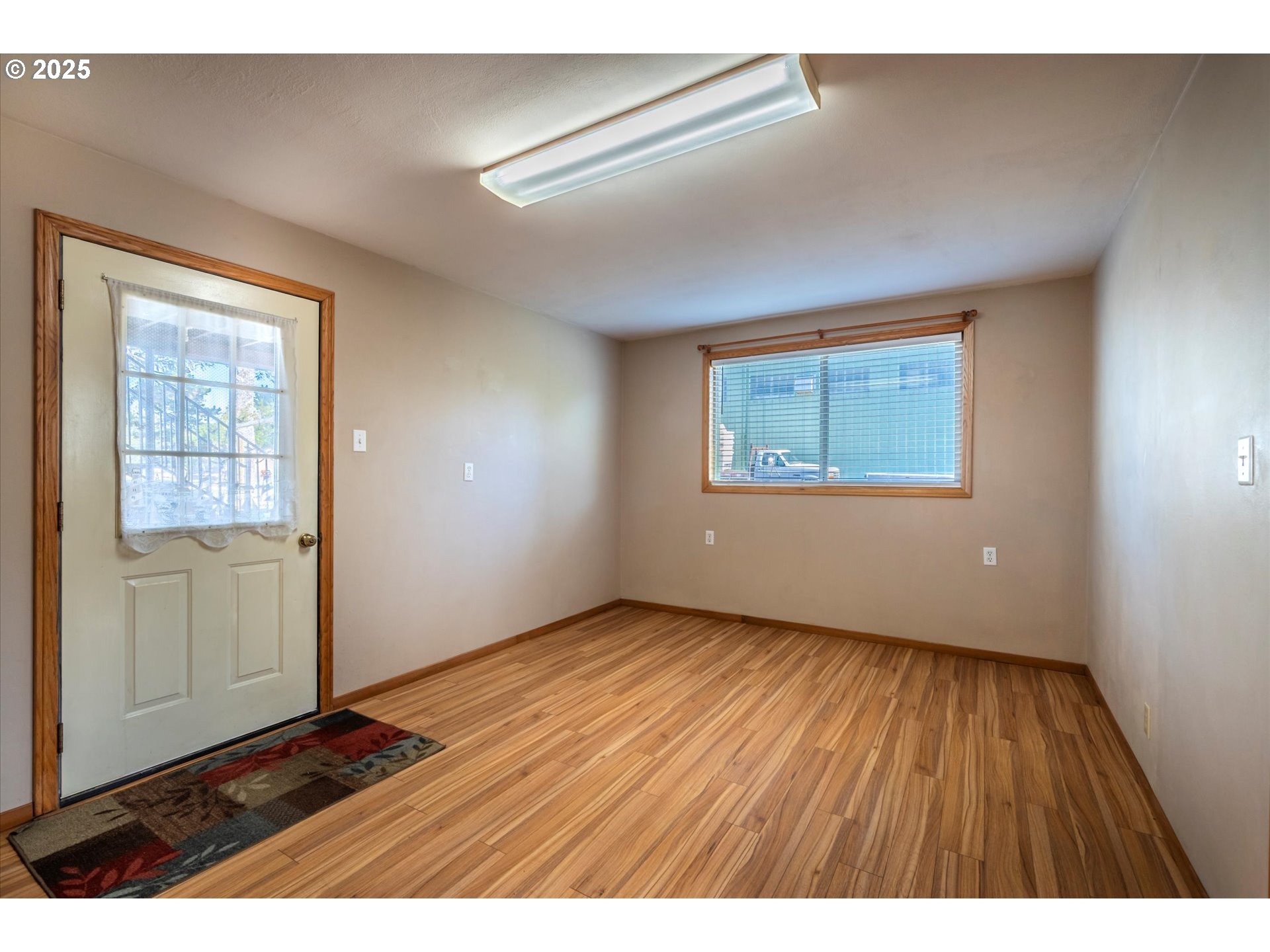 63347 Charleston Road Coos Bay, OR 97420 - Photo 28 of 48 an empty room with wooden floor and windows