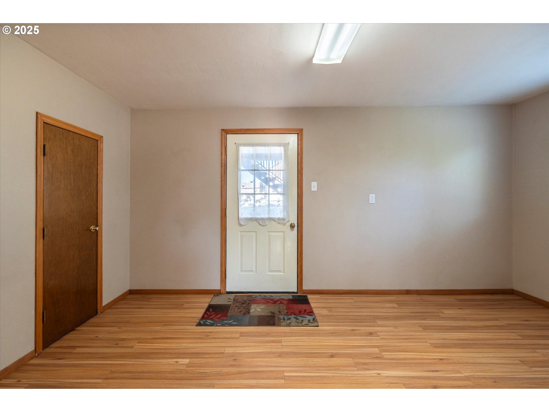 63347 Charleston Road Coos Bay, OR 97420 - Photo 29 of 48 a view of an empty room with wooden floor and window
