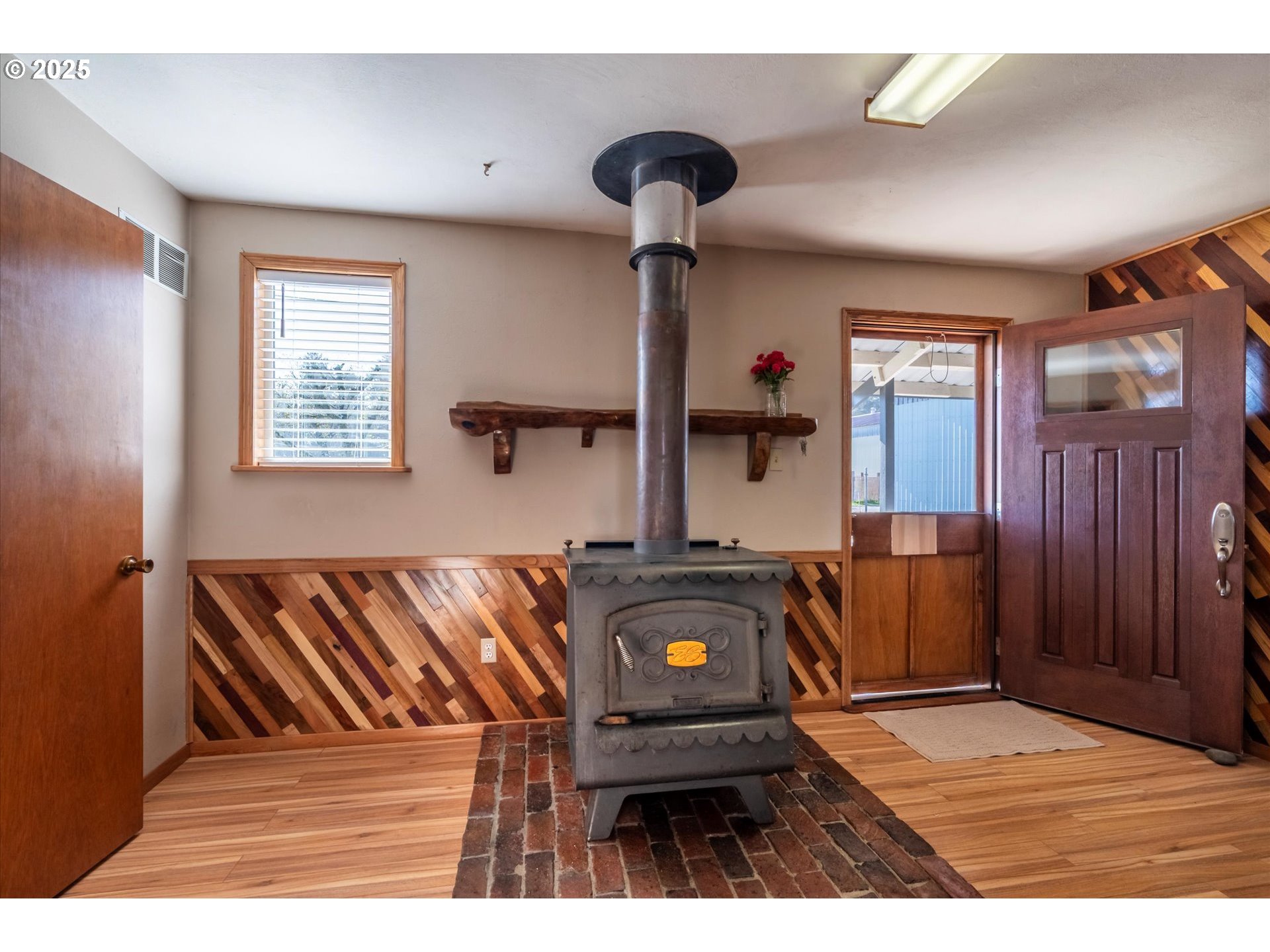 63347 Charleston Road Coos Bay, OR 97420 - Photo 30 of 48 a bedroom with a bed and wooden floor