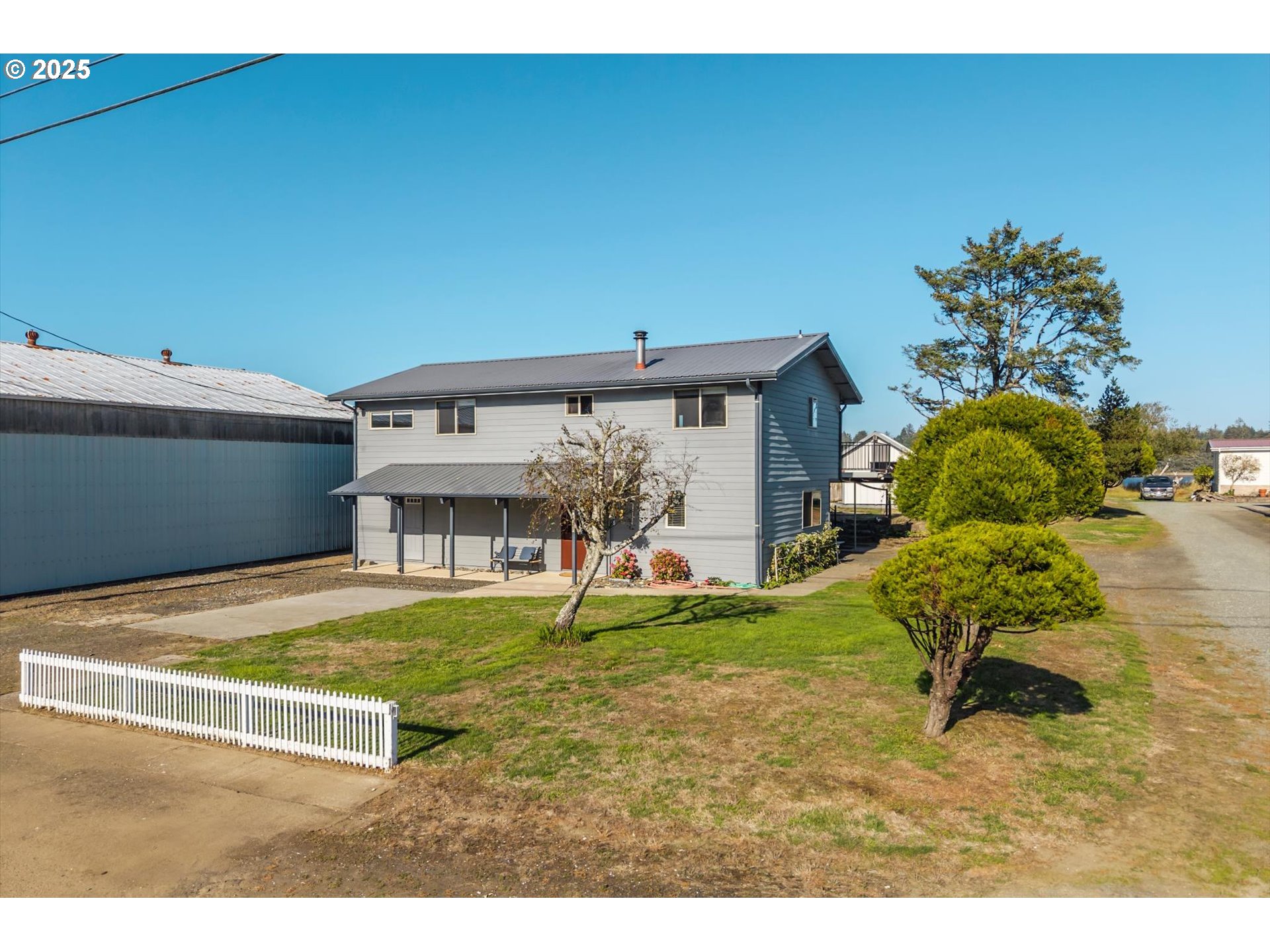 63347 Charleston Road Coos Bay, OR 97420 - Photo 5 of 48 a view of a house with a yard and sitting area