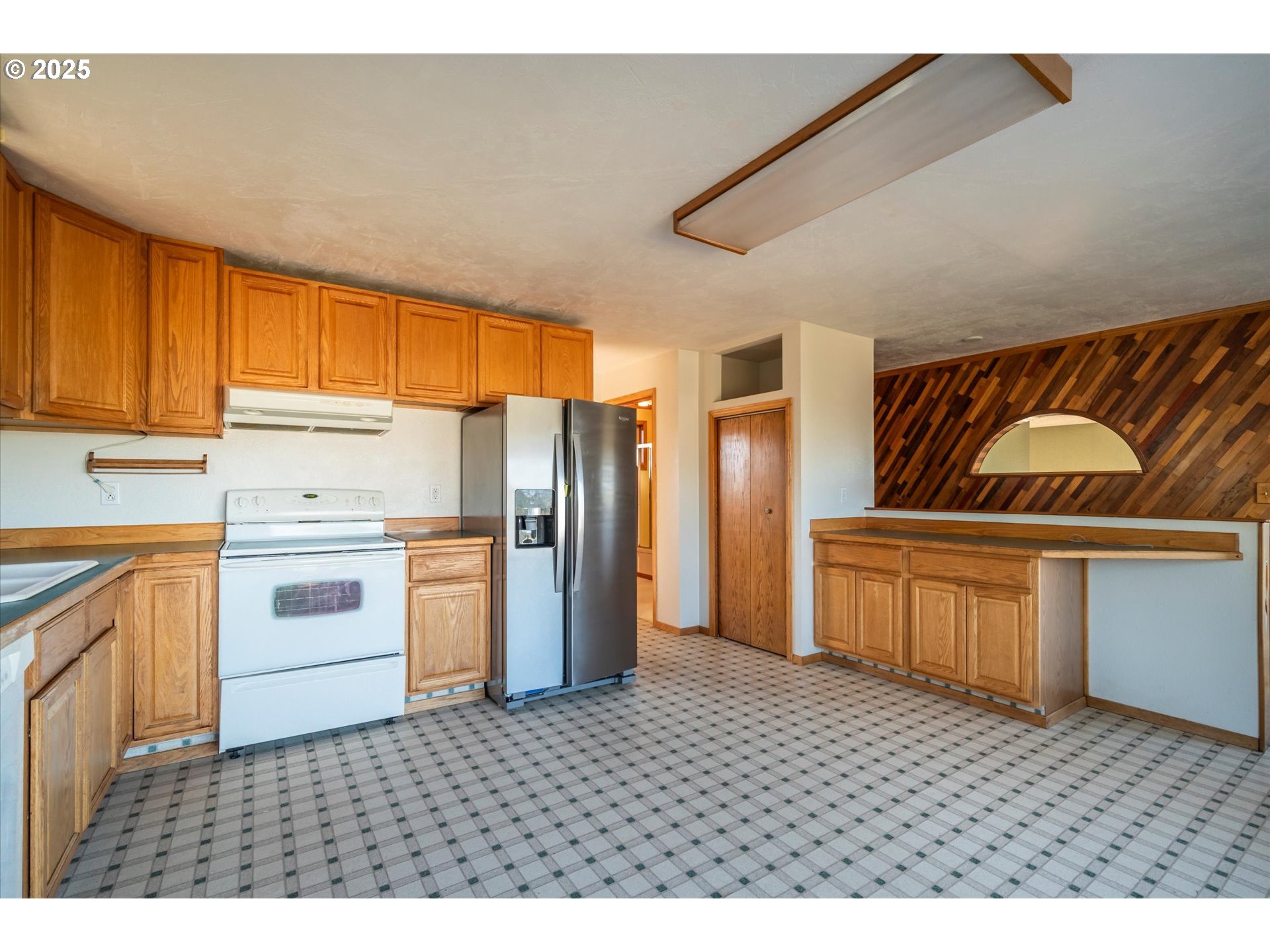 63347 Charleston Road Coos Bay, OR 97420 - Photo 10 of 48 a kitchen with stainless steel appliances a refrigerator and cabinets