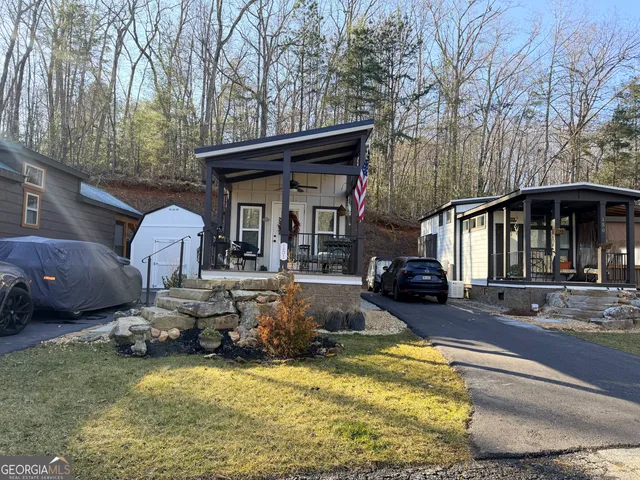 a view of a house with a yard patio and fire pit