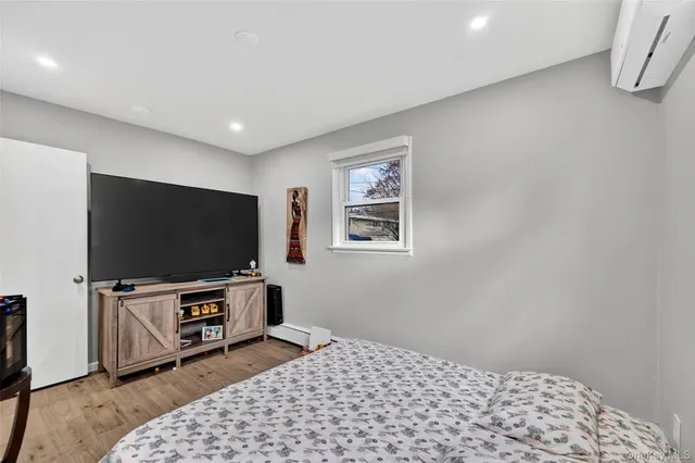 a bedroom with a large bed and a painting on the wall