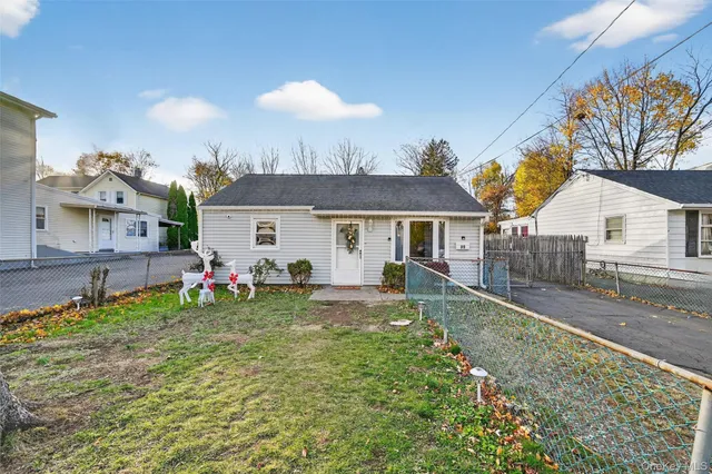 a view of a house with backyard and sitting area