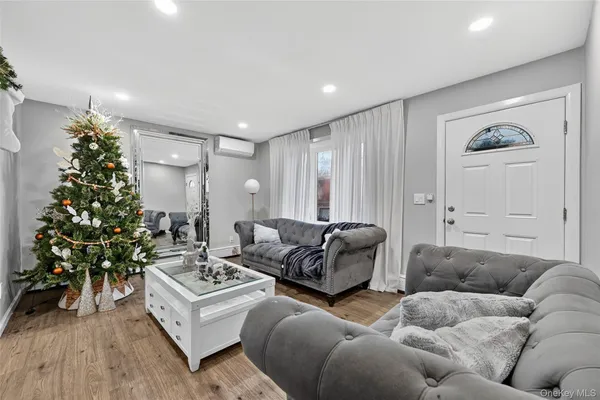 a living room with furniture potted plant and a window