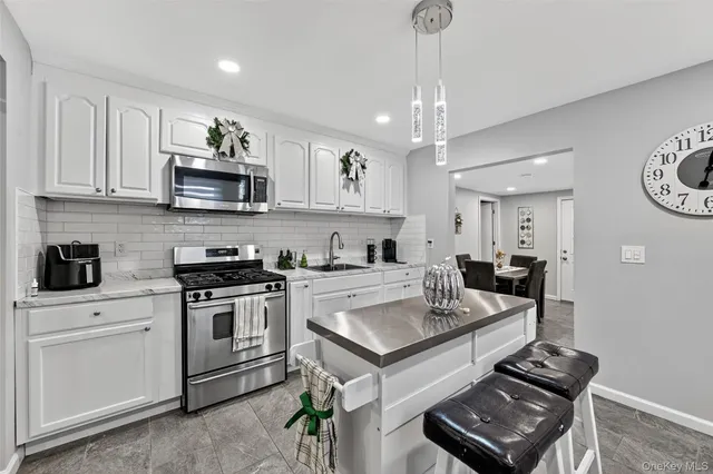 a view of kitchen with sink microwave and cabinets