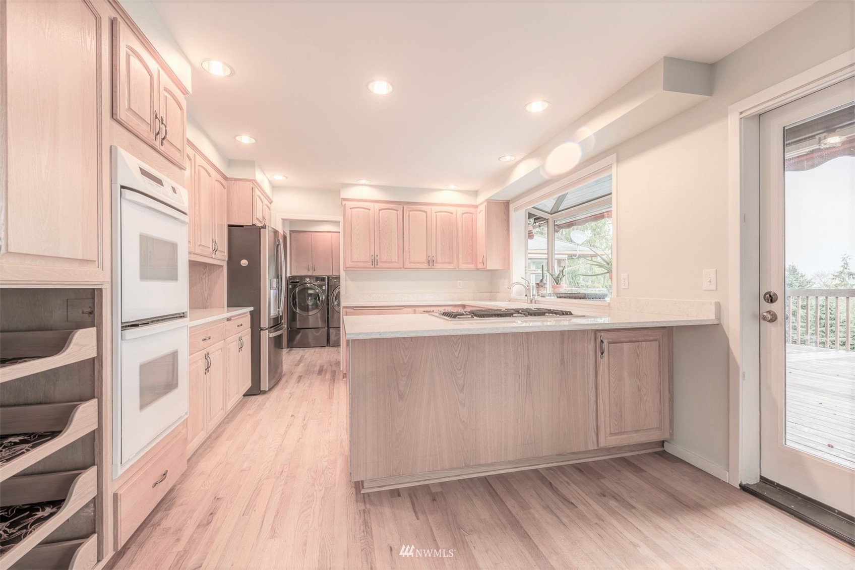 10029 Wagner Road Snohomish, WA 98290 - Photo 14 of 40 a large kitchen with stainless steel appliances a large counter top and wooden floors
