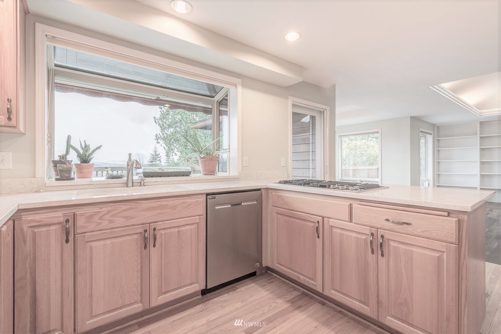 10029 Wagner Road Snohomish, WA 98290 - Photo 18 of 40 a kitchen with white cabinets and a large window