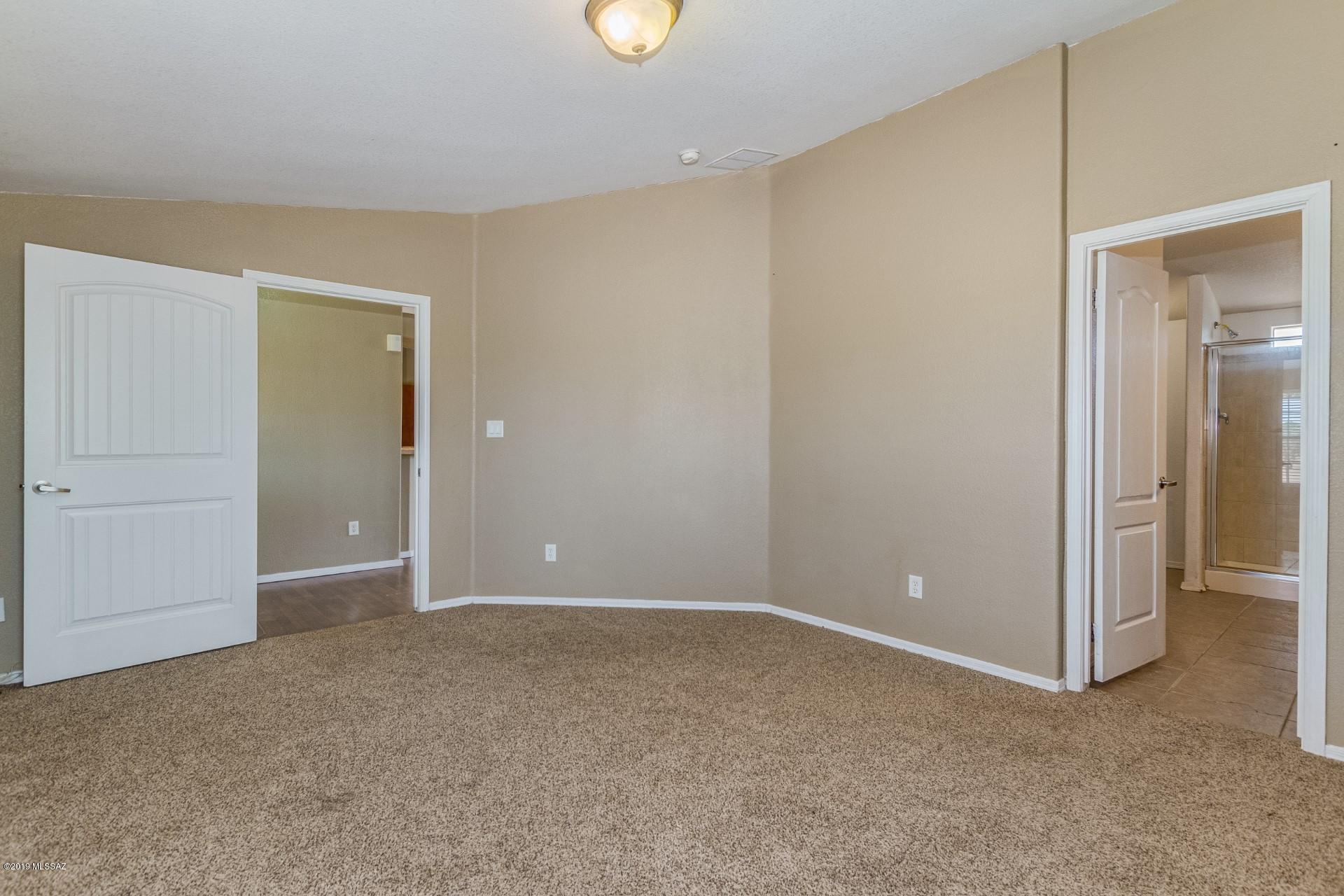 8945 West Bopp Road Tucson, AZ 85735 - Photo 10 of 21 an empty room with closet and mirror