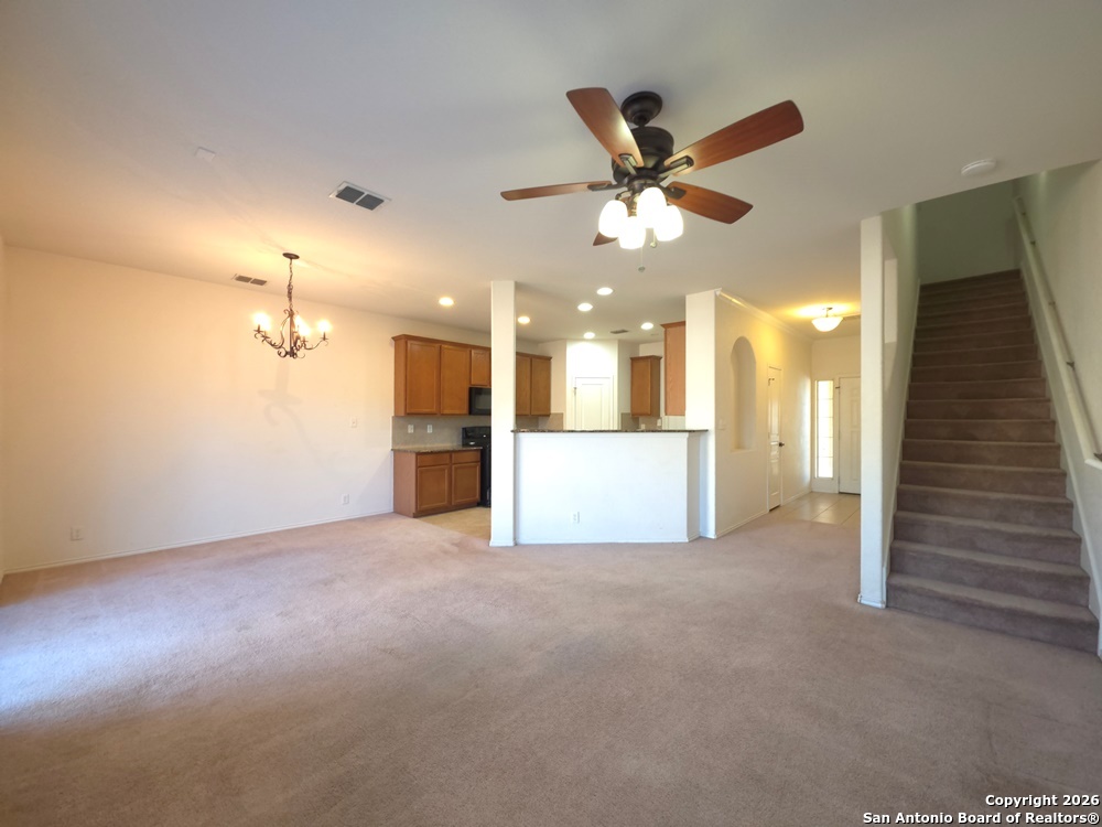 3907 Paradiso Loop San Antonio, TX 78260 - Photo 12 of 30 a view of a livingroom with a ceiling fan and kitchen view
