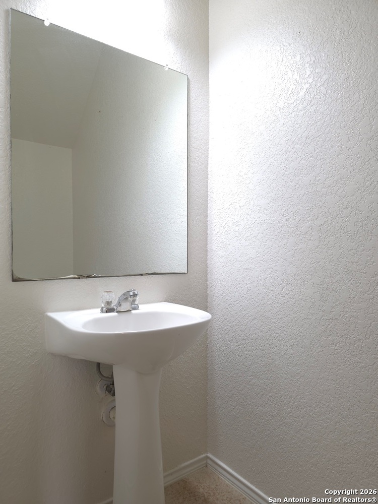 3907 Paradiso Loop San Antonio, TX 78260 - Photo 25 of 30 a bathroom with a sink and a mirror
