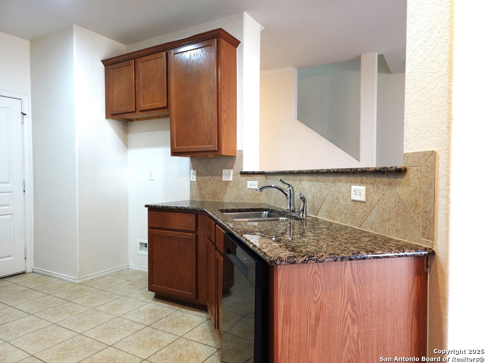 3907 Paradiso Loop San Antonio, TX 78260 - Photo 5 of 30 a kitchen with a granite countertop sink and cabinets