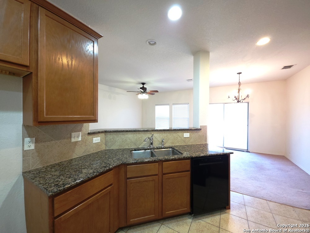 3907 Paradiso Loop San Antonio, TX 78260 - Photo 6 of 30 a kitchen with granite countertop a sink and cabinets