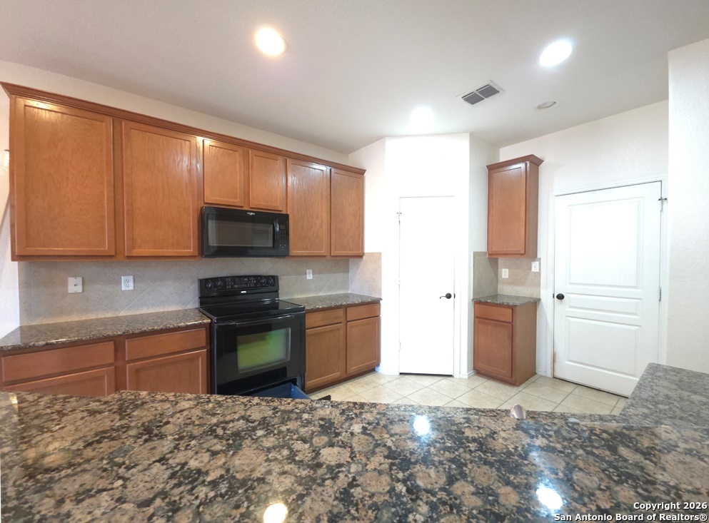 3907 Paradiso Loop San Antonio, TX 78260 - Photo 7 of 30 a kitchen with stainless steel appliances granite countertop a refrigerator sink and stove