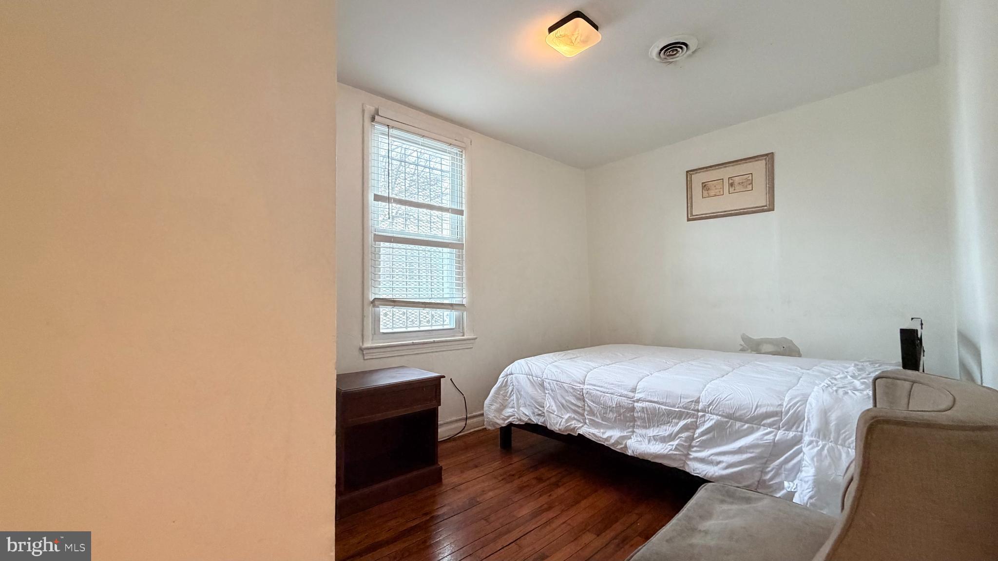 830 19th Street Northeast Washington, DC 20002 - Photo 12 of 13 a bedroom with a bed and a window