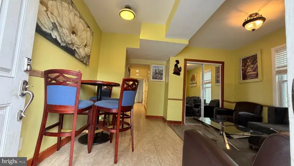 a view of a dining room with furniture and chandelier