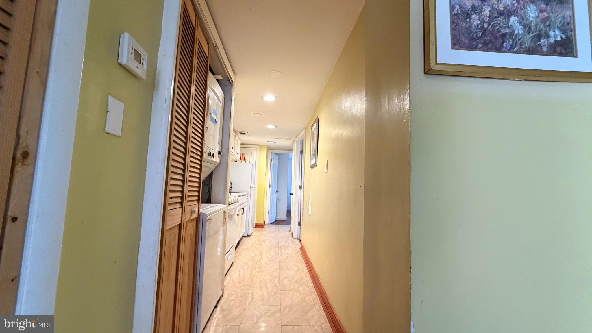 830 19th Street Northeast Washington, DC 20002 - Photo 5 of 13 a view of a hallway with wooden floor and a bathroom
