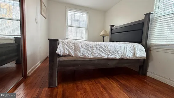 a bed sitting in a bedroom next to a window