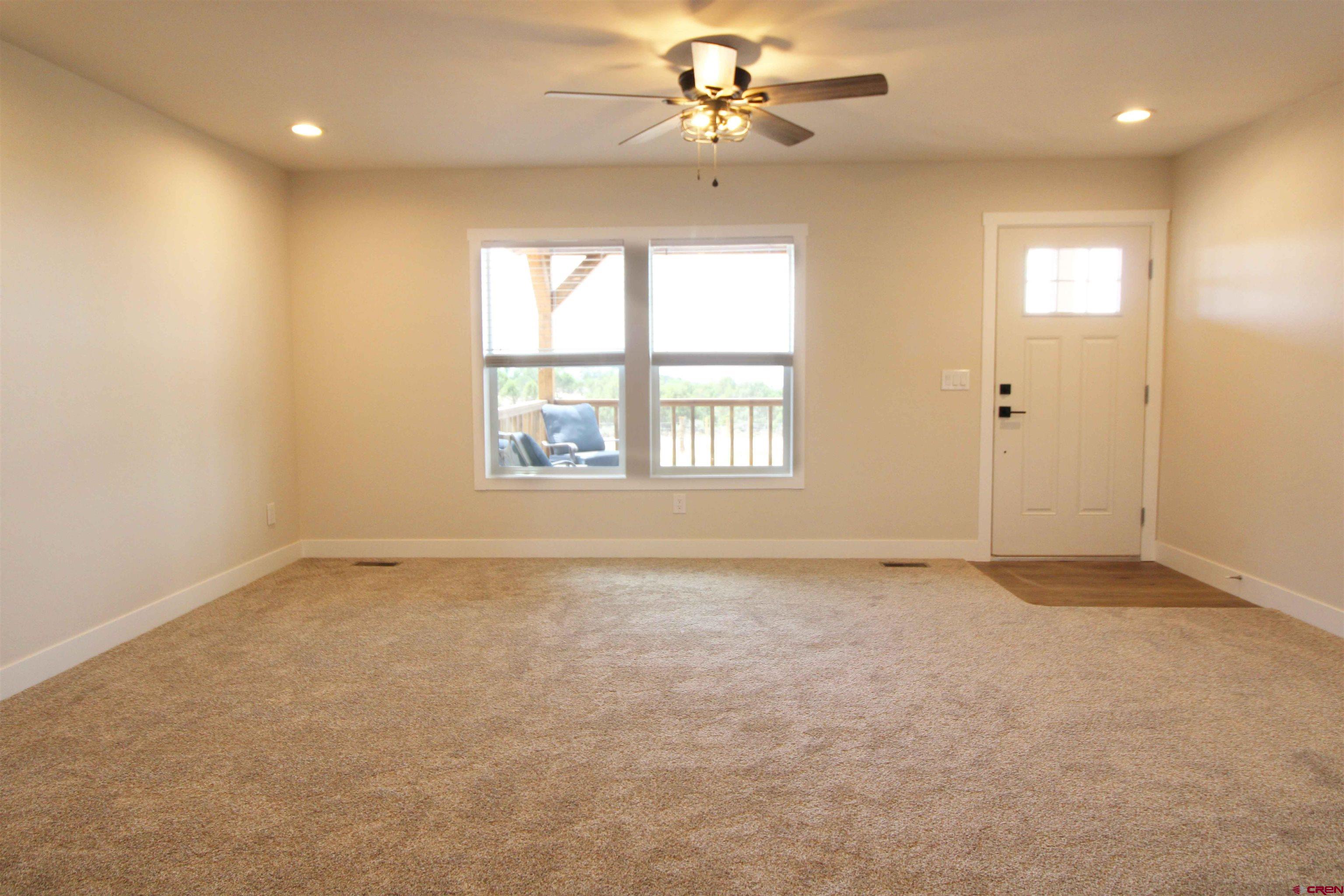 29173 P 50 Road Hotchkiss, CO 81419 - Photo 14 of 38 an empty room with chandelier fan and windows