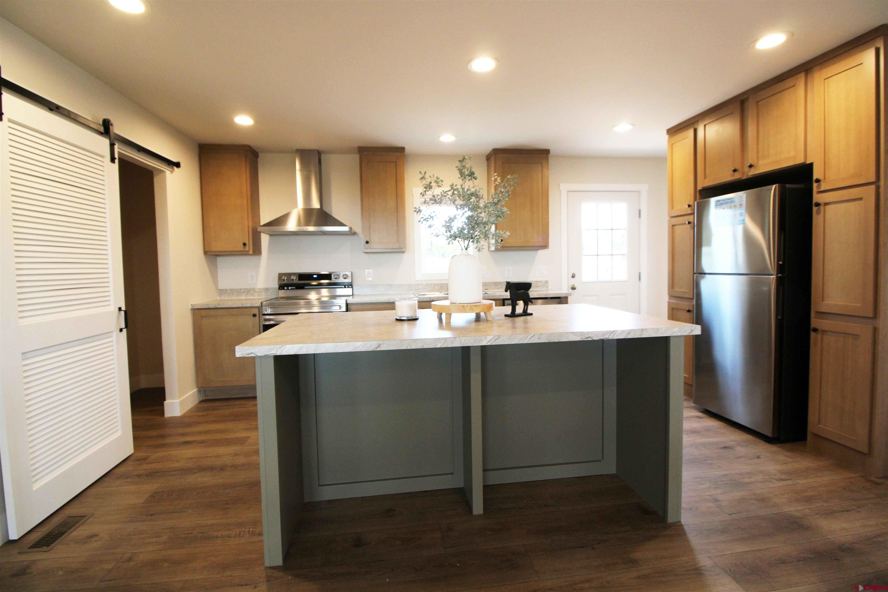 29173 P 50 Road Hotchkiss, CO 81419 - Photo 17 of 38 a kitchen with kitchen island a sink stainless steel appliances and cabinets