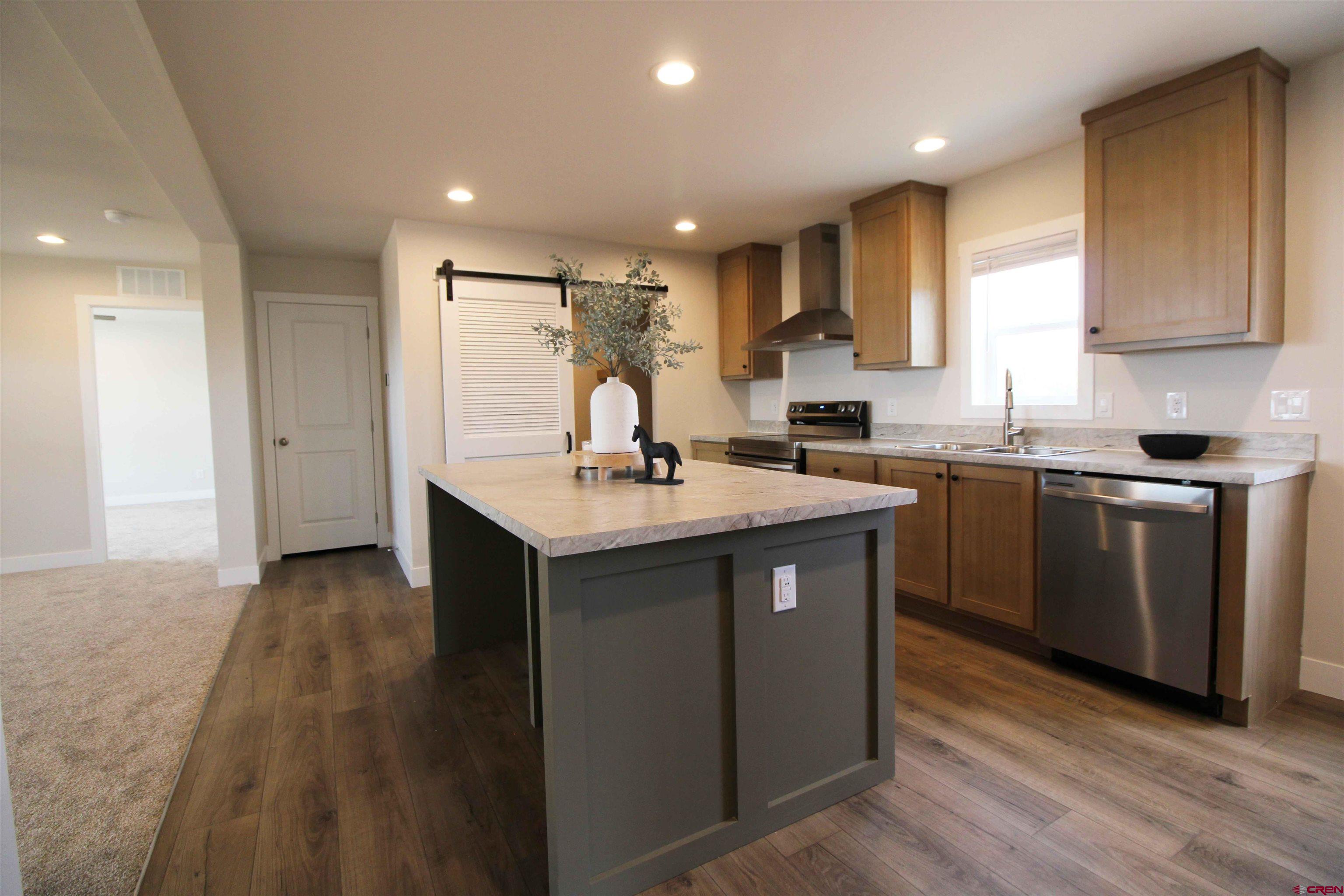 29173 P 50 Road Hotchkiss, CO 81419 - Photo 19 of 38 a kitchen with kitchen island sink stove and refrigerator