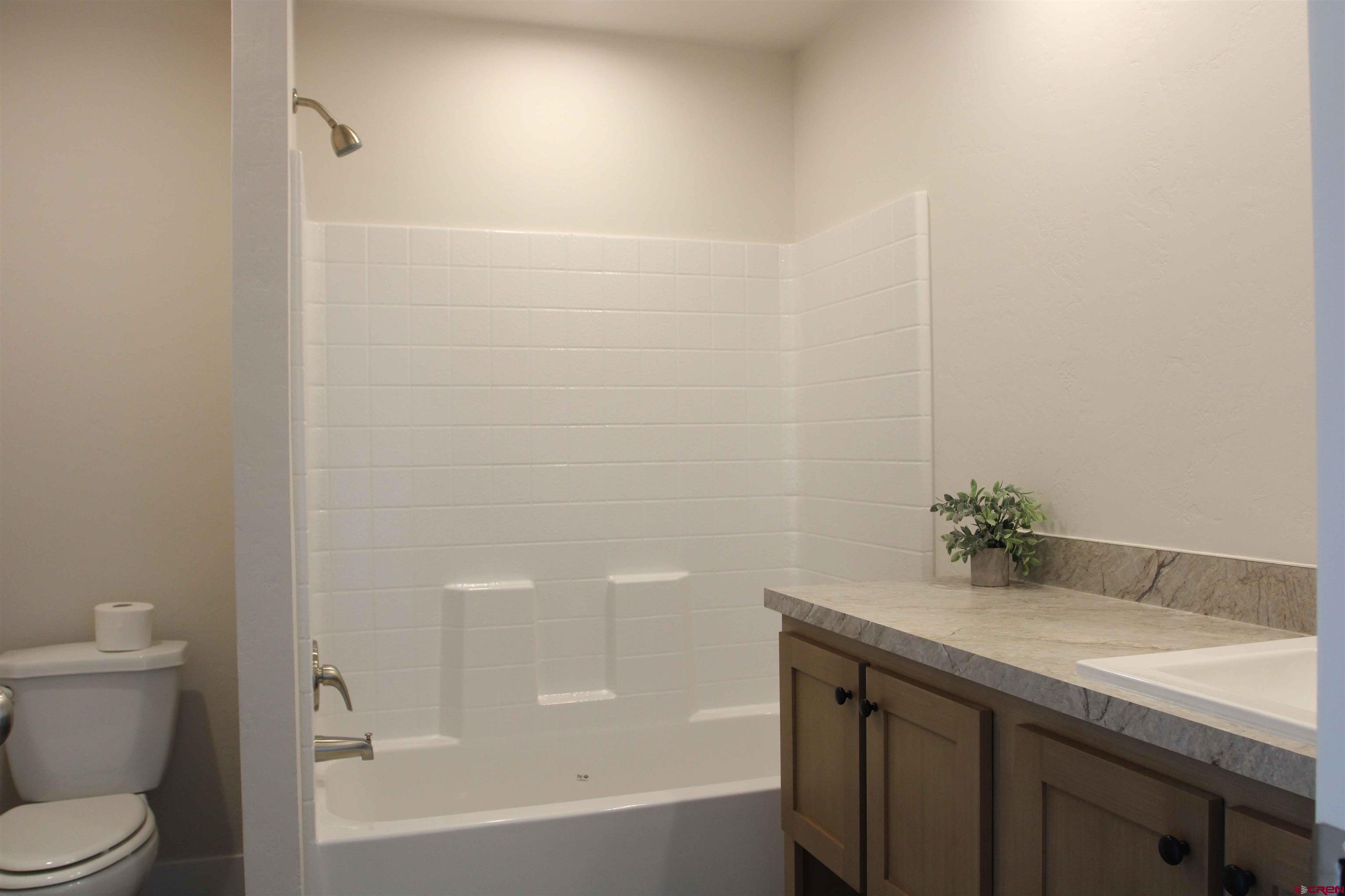 29173 P 50 Road Hotchkiss, CO 81419 - Photo 27 of 38 a bathroom with a granite countertop sink a toilet and shower