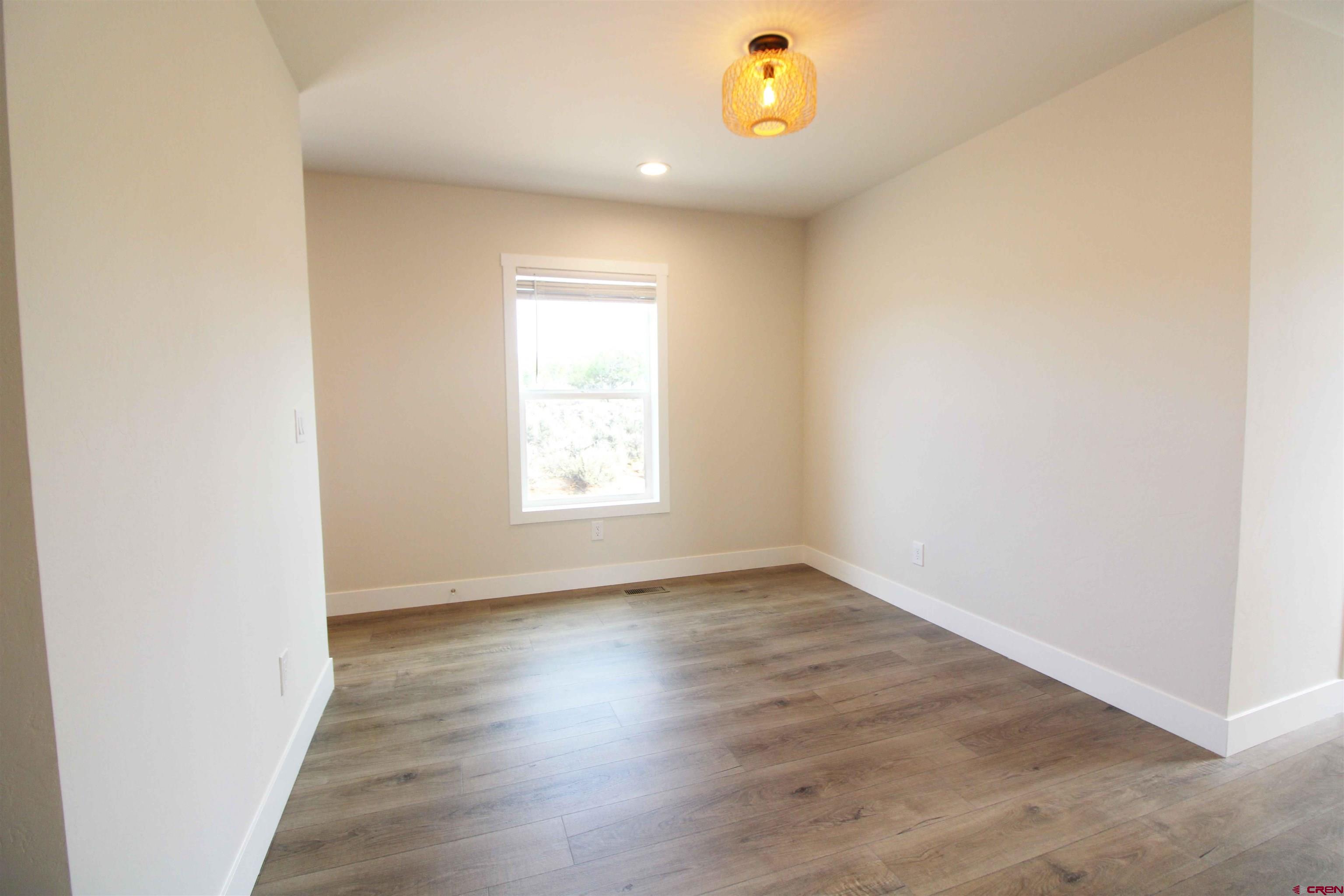 29173 P 50 Road Hotchkiss, CO 81419 - Photo 30 of 38 an empty room with wooden floor and windows