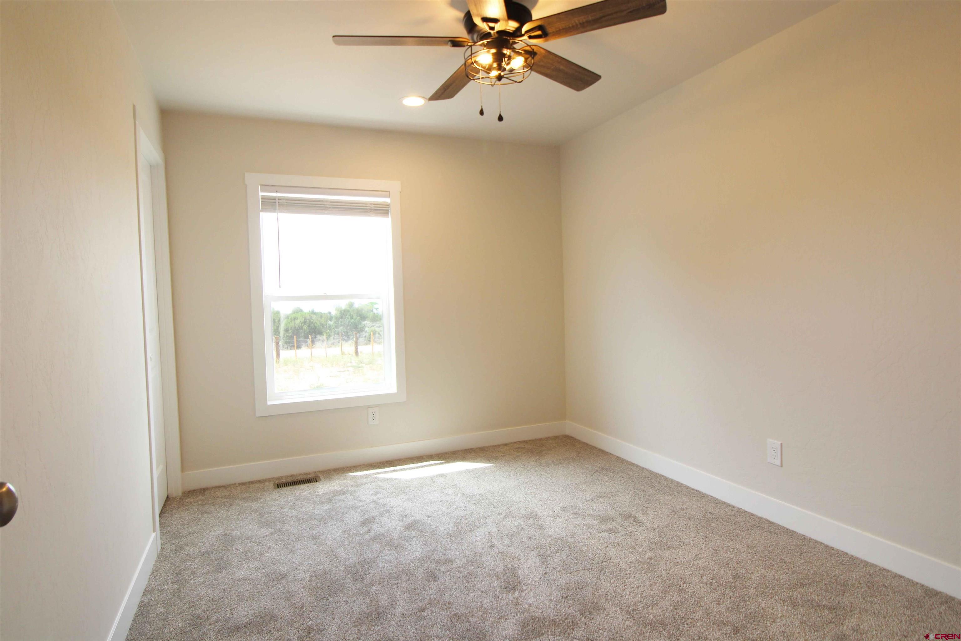 29173 P 50 Road Hotchkiss, CO 81419 - Photo 5 of 38 an empty room with a window and a fan